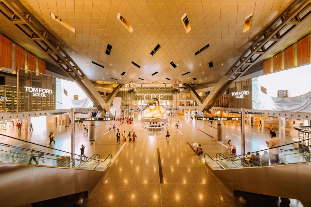 View of a spacious modern terminal interior with travelers and architectural features.