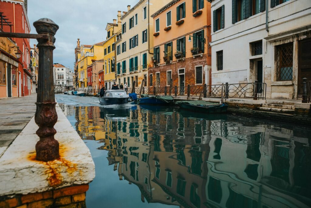 Charming view of a Venetian canal lined with colorful historic buildings and boats.